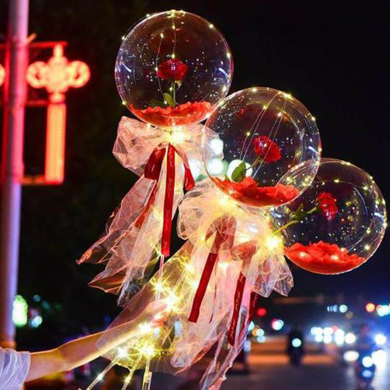 LED luminous balloon rose bouquet with transparent balloons, red roses inside, fairy lights, and decorative ribbons for romantic decoration or gift.