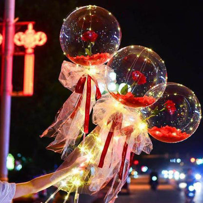 LED luminous balloon rose bouquet with transparent balloons, red roses inside, fairy lights, and decorative ribbons for romantic decoration or gift.