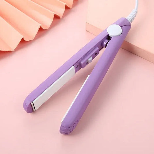 Mini portable purple ceramic hair iron curler and straightener on pink background