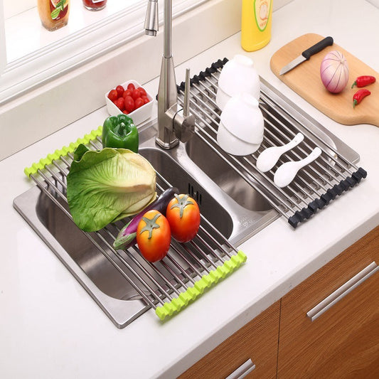 Foldable stainless steel kitchen sink rack with vegetables and utensils on it for drying and draining.